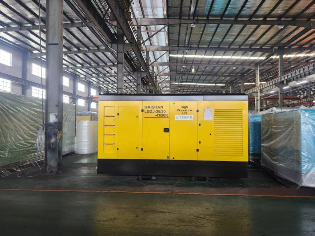 screw air compressor, stationary industrial compressor displayed in factory workshop