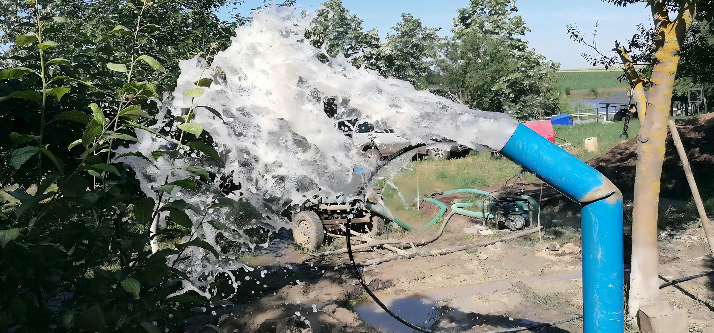 Water well air‑drilling site, strong water gushing out from blue discharge pipe after borehole completion in Europe project